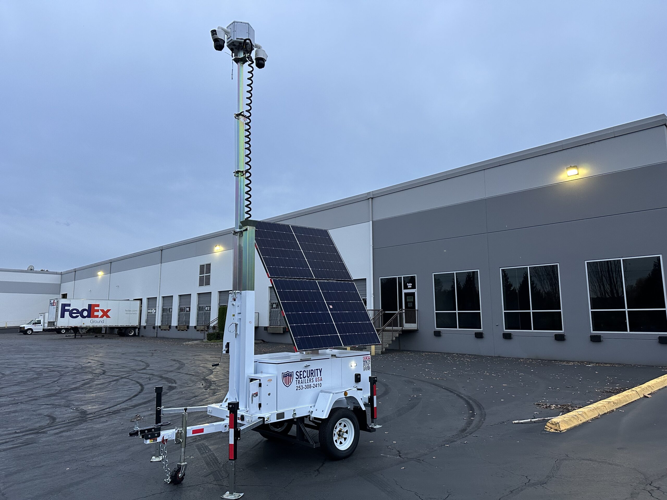 Mobile CCTV camera trailer monitoring parking lot security and activity