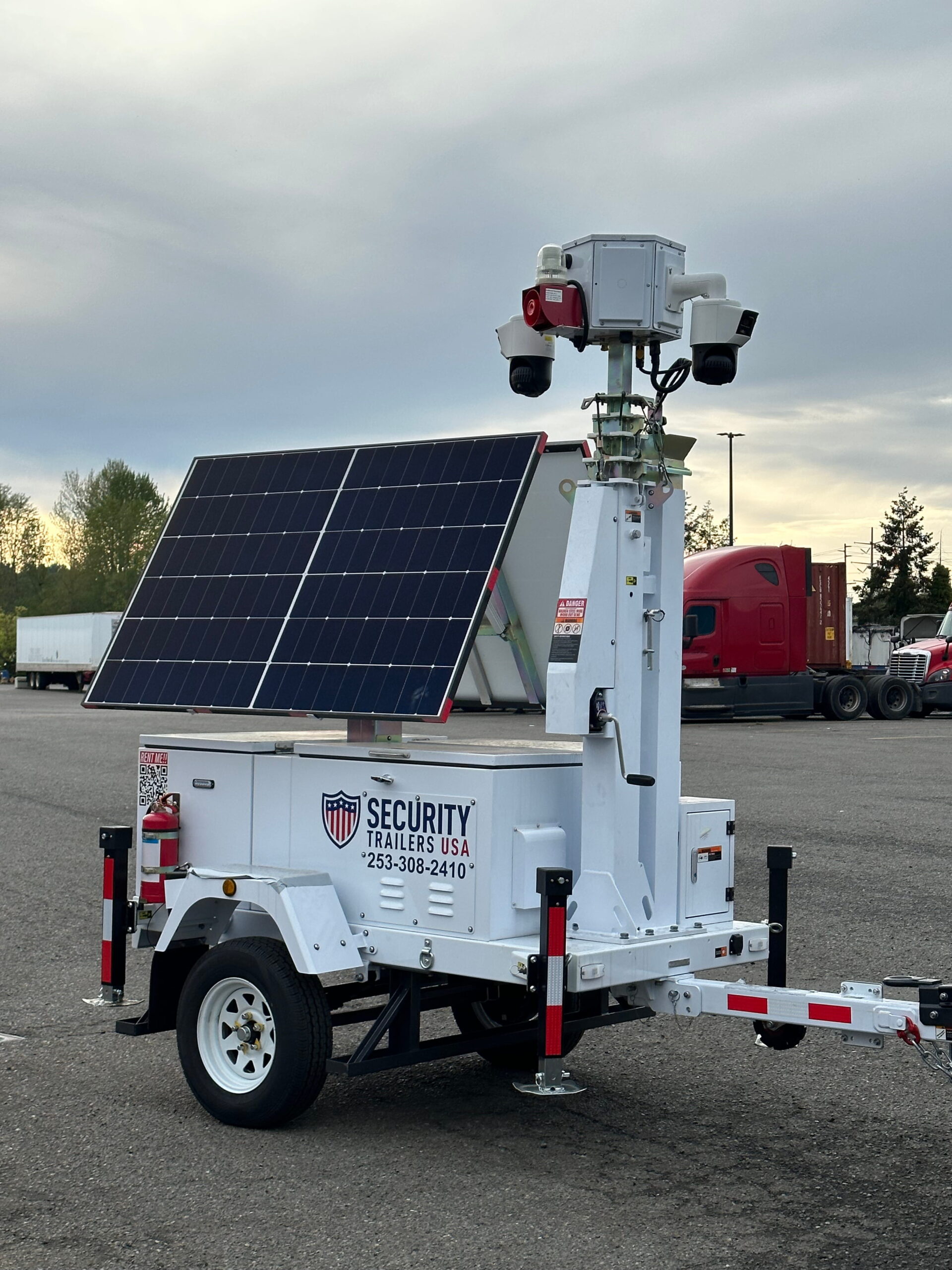 mobile-surveillance-trailer-industrial-yard-security Solar powered surveillance trailer showing equipment compartment and solar panel system